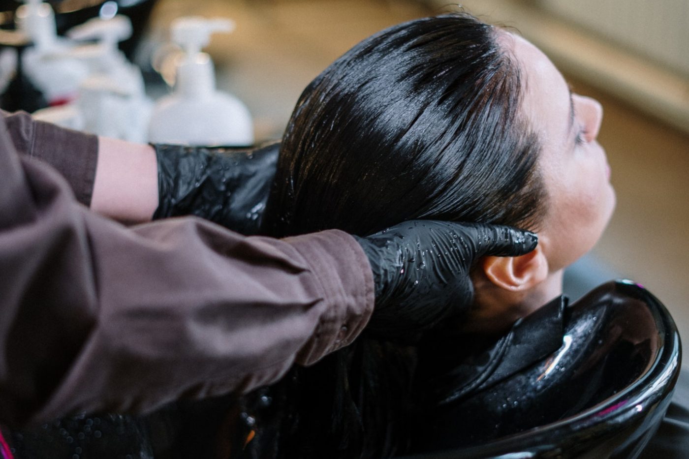Hair being washed at a salon shampoo basin